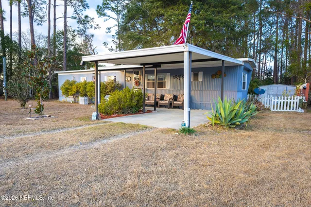 a view of a house with porch and garden