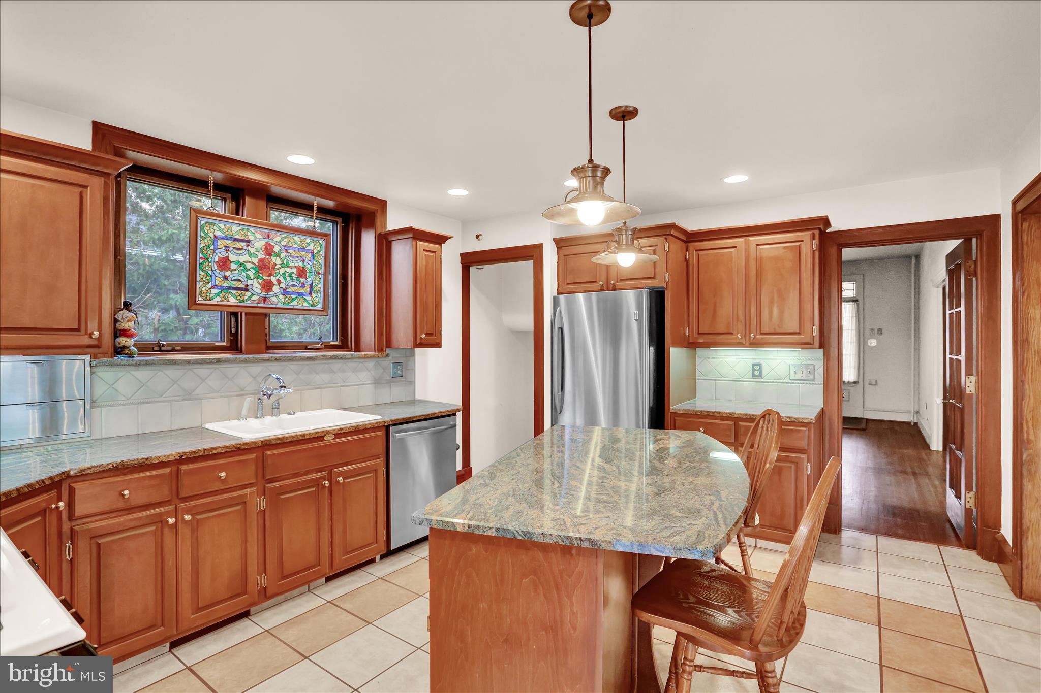4100 Kutztown Road Temple, PA 19560 - Photo 21 of 67 a kitchen with stainless steel appliances granite countertop a kitchen island a cabinets a dining table and chairs