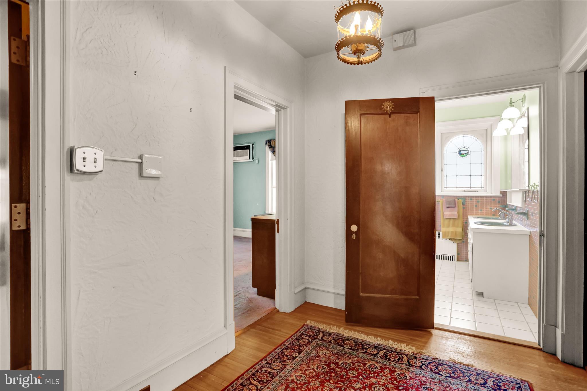 4100 Kutztown Road Temple, PA 19560 - Photo 29 of 67 a view of a hallway with wooden floor and a bathroom