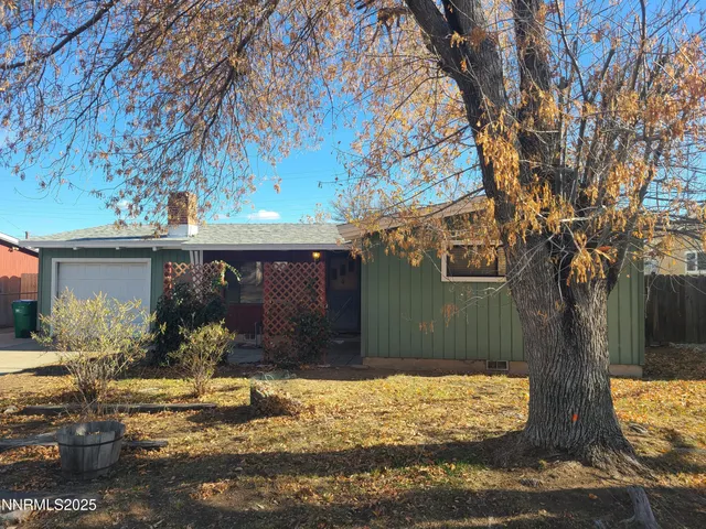 a view of a house with a yard covered with snow