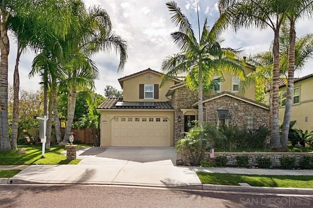 6991 Goldstone Road Carlsbad, CA 92009 - Photo 1 of 25 a front view of a house with a yard and garage