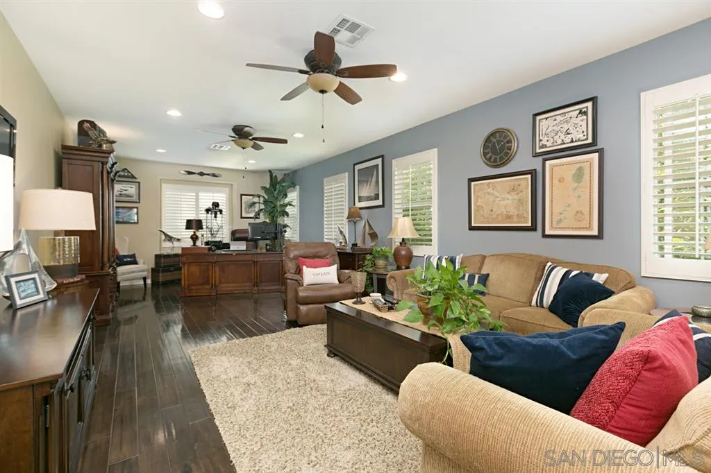 6991 Goldstone Road Carlsbad, CA 92009 - Photo 15 of 25 a living room with furniture wooden floor and a large window