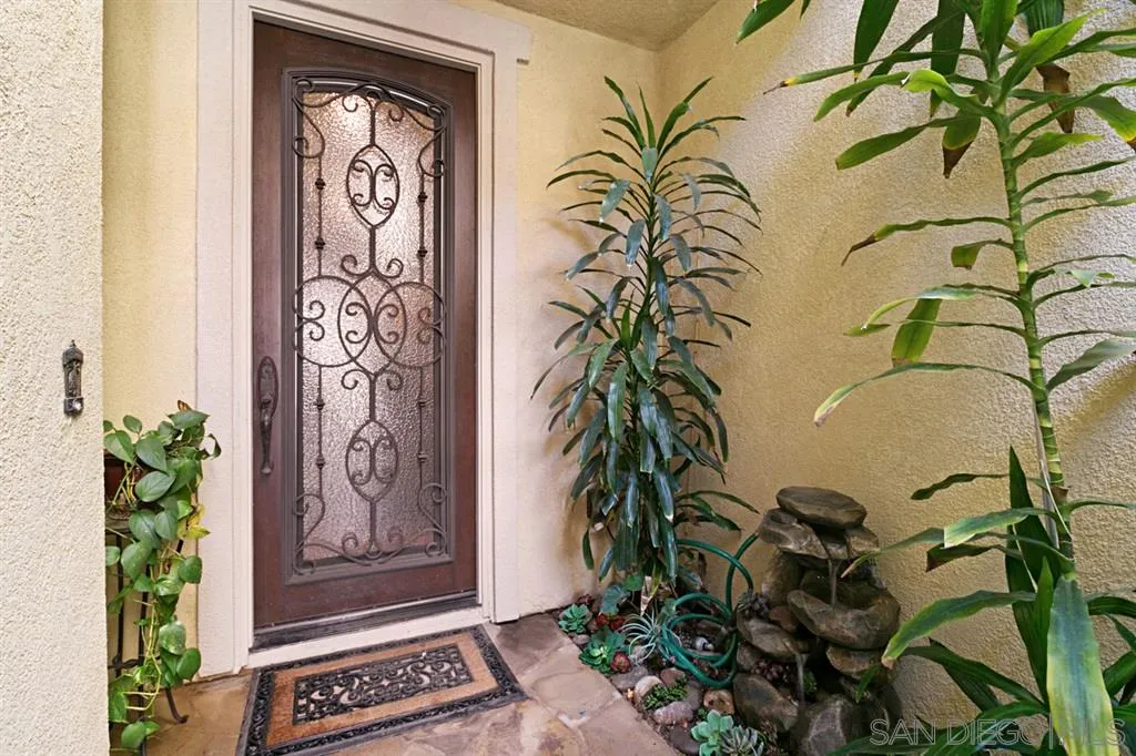 6991 Goldstone Road Carlsbad, CA 92009 - Photo 2 of 25 a view of front door with yellow lighting