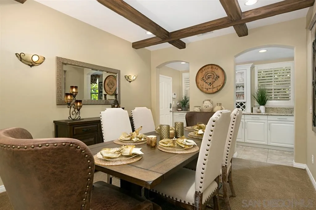 6991 Goldstone Road Carlsbad, CA 92009 - Photo 3 of 25 a view of a dining room with furniture and a large window