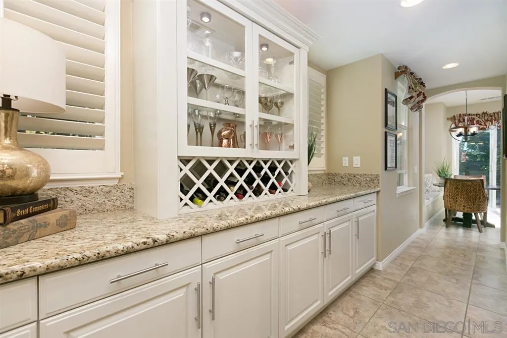 6991 Goldstone Road Carlsbad, CA 92009 - Photo 4 of 25 a kitchen with granite countertop a sink and a white cabinets