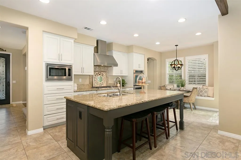 6991 Goldstone Road Carlsbad, CA 92009 - Photo 5 of 25 a kitchen with stainless steel appliances granite countertop a sink a stove a refrigerator and a oven