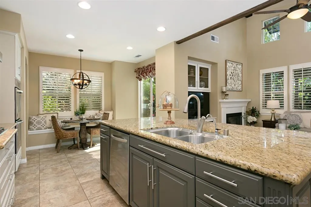 6991 Goldstone Road Carlsbad, CA 92009 - Photo 6 of 25 a large kitchen with kitchen island granite countertop a sink and a stove