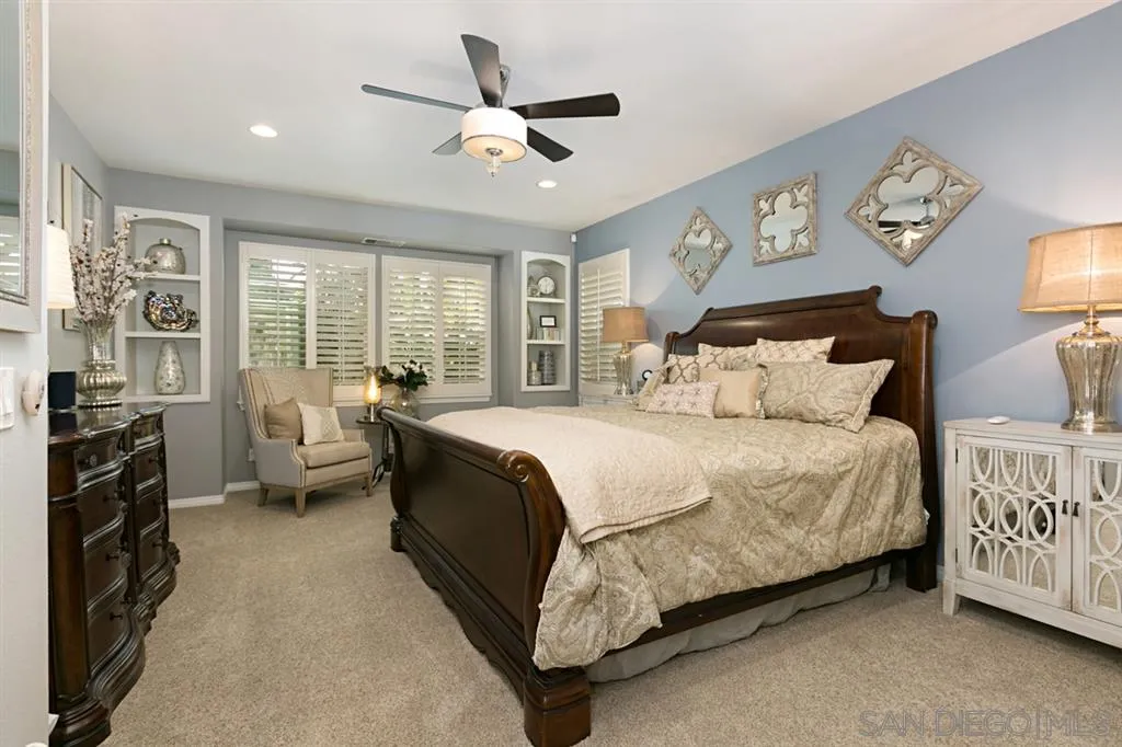 6991 Goldstone Road Carlsbad, CA 92009 - Photo 8 of 25 a spacious bedroom with a bed a couch and a large window
