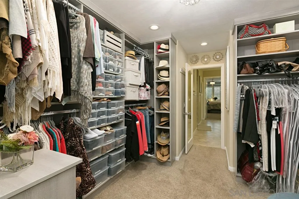 6991 Goldstone Road Carlsbad, CA 92009 - Photo 10 of 25 a view of walk in closet with clothes and shoes