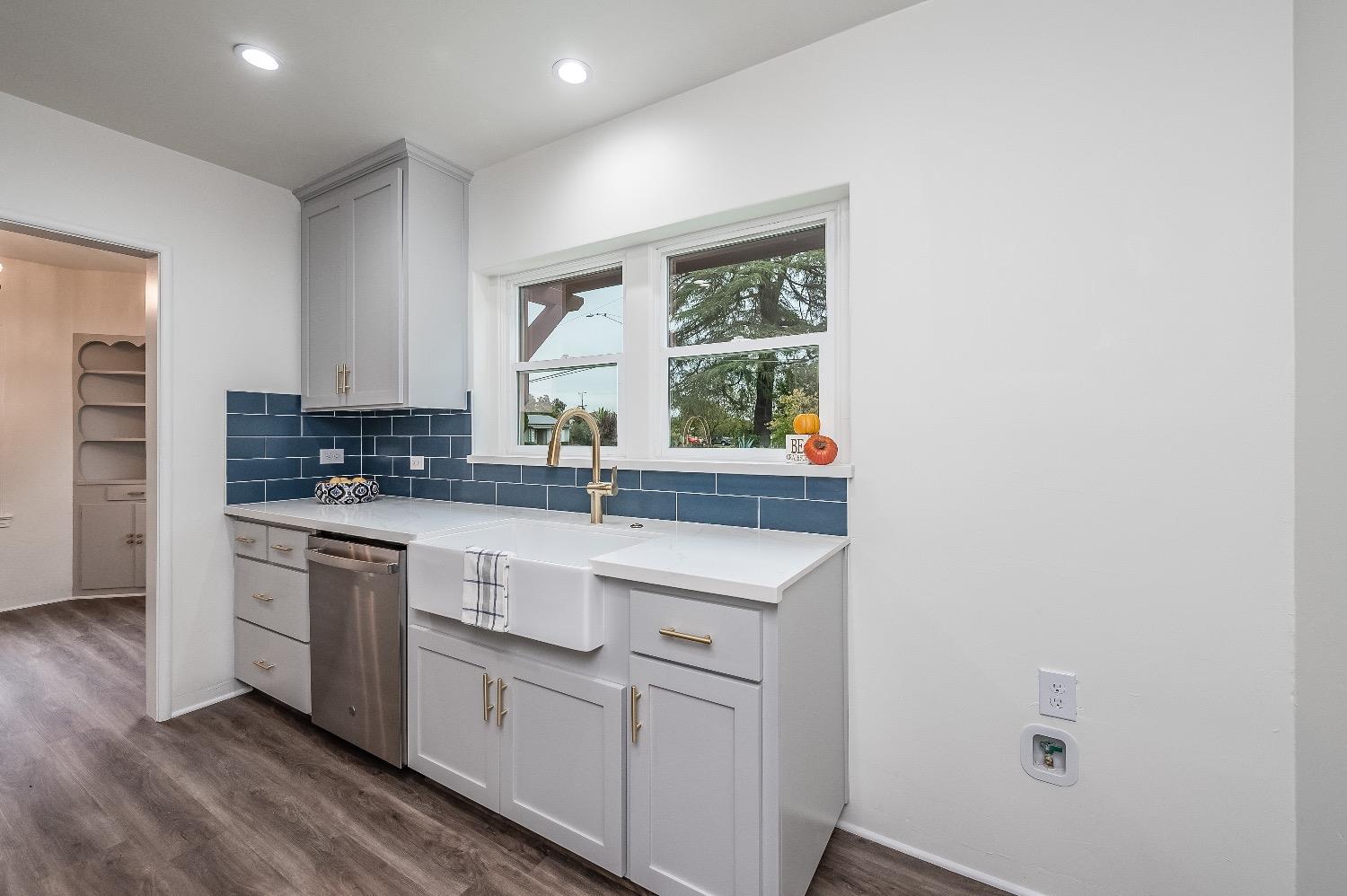 1600 West 5th Street Madera, CA 93637 - Photo 17 of 46 a kitchen with white cabinets and white appliances