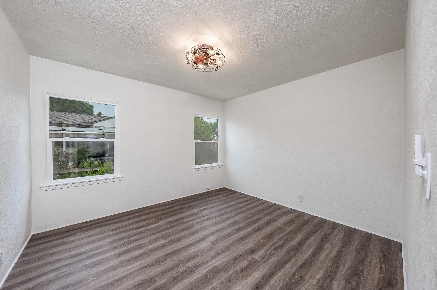1600 West 5th Street Madera, CA 93637 - Photo 20 of 46 a view of an empty room with wooden floor and a window