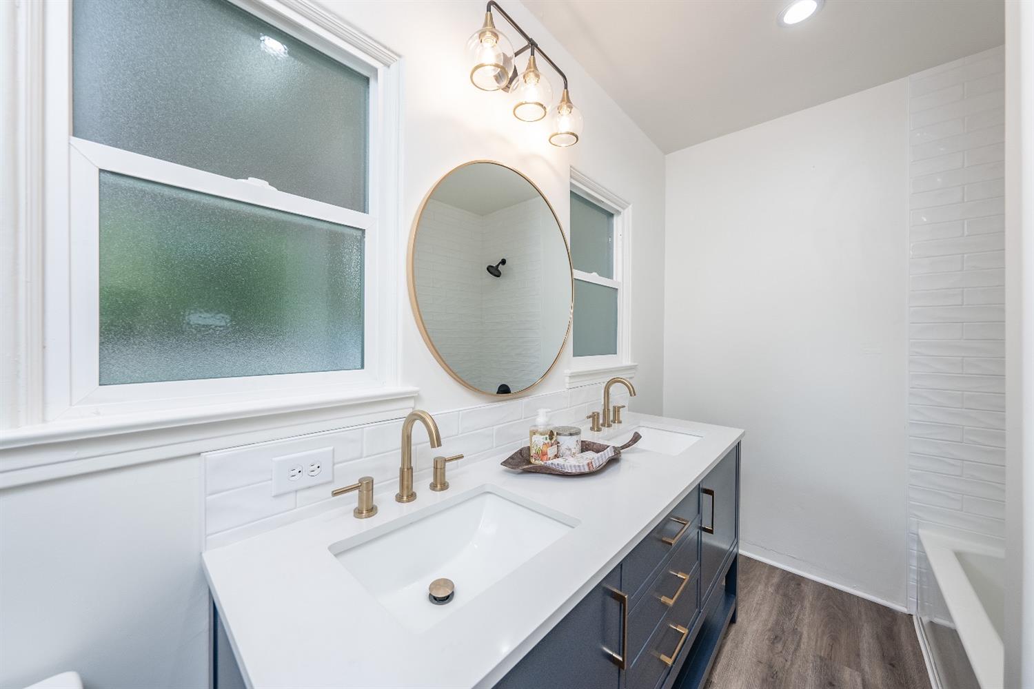 1600 West 5th Street Madera, CA 93637 - Photo 24 of 46 a bathroom with a sink vanity and mirror