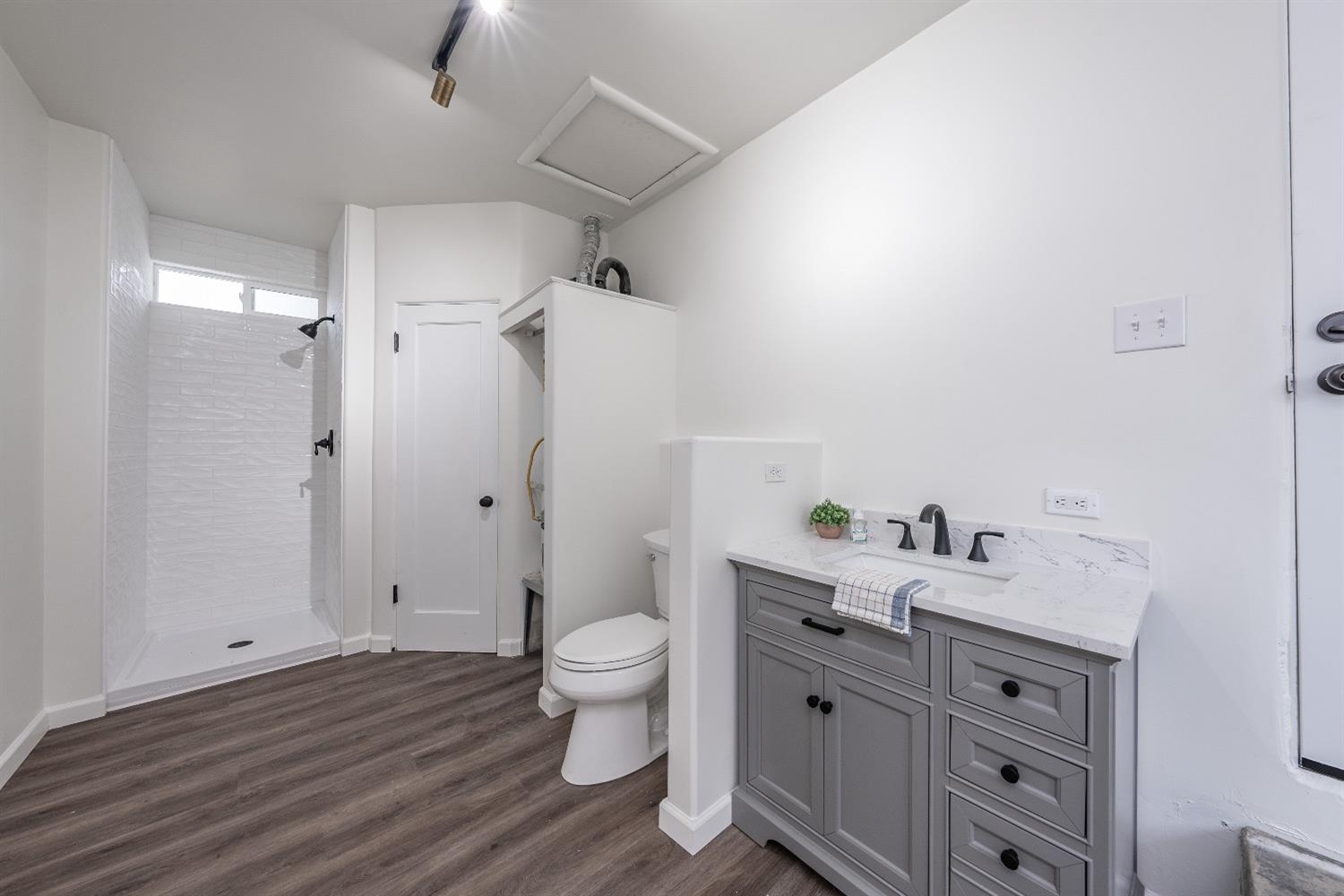 1600 West 5th Street Madera, CA 93637 - Photo 30 of 46 a spacious bathroom with a double vanity sink a toilet and a shower