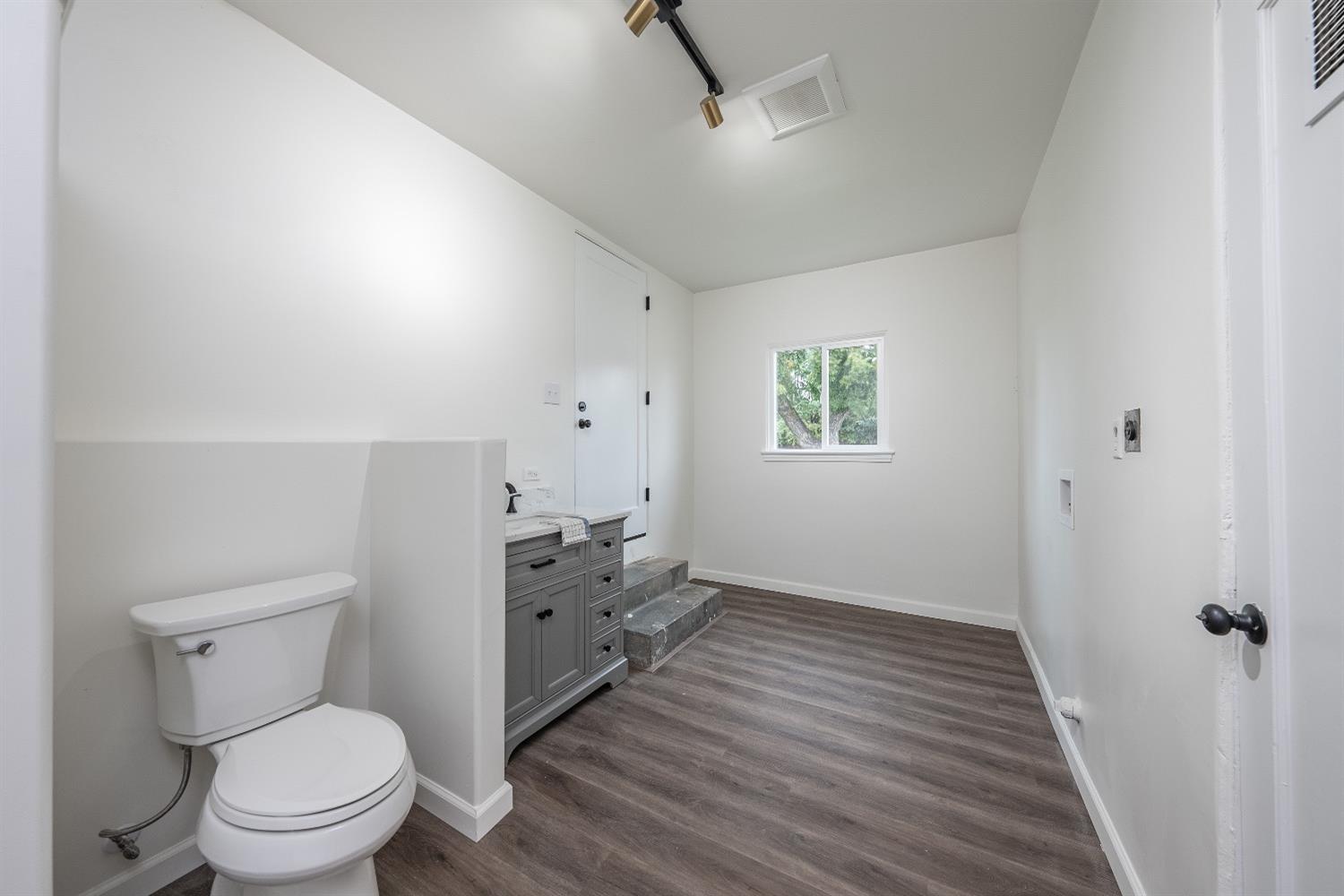 1600 West 5th Street Madera, CA 93637 - Photo 32 of 46 a bathroom with a toilet sink and a mirror