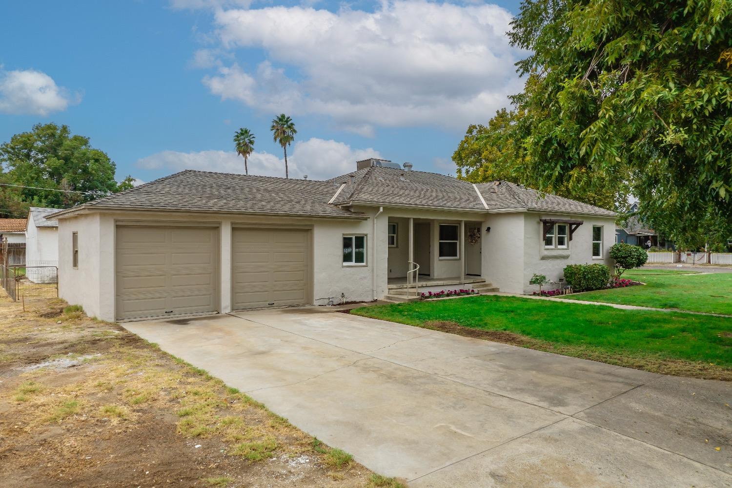 1600 West 5th Street Madera, CA 93637 - Photo 34 of 46 a front view of a house with a yard and trees