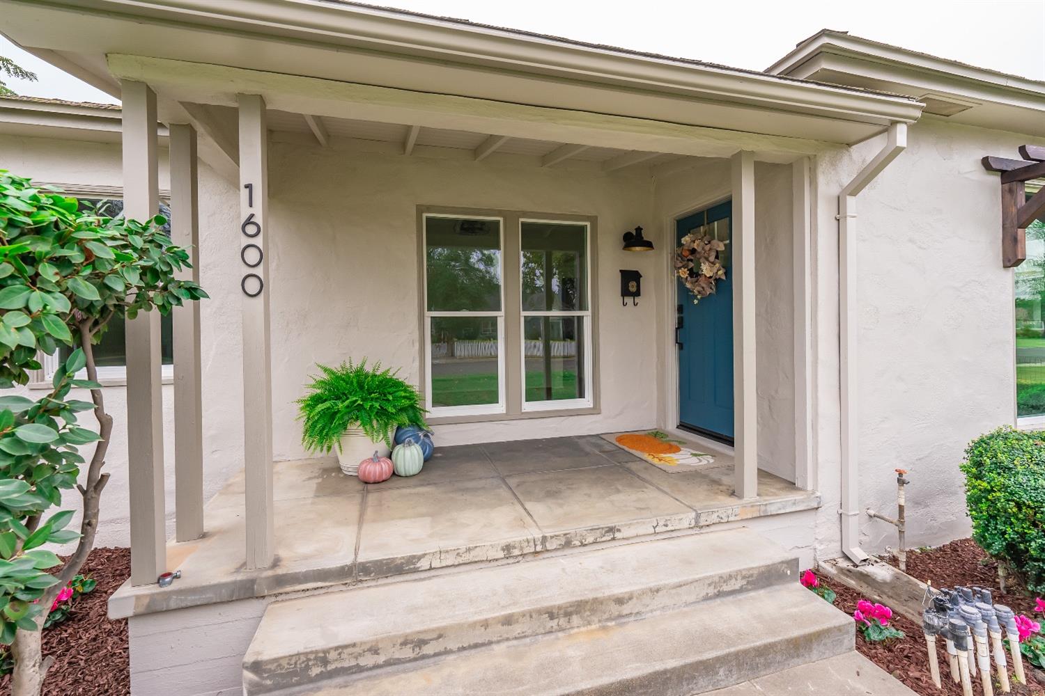 1600 West 5th Street Madera, CA 93637 - Photo 4 of 46 a potted plant sitting in front of a house
