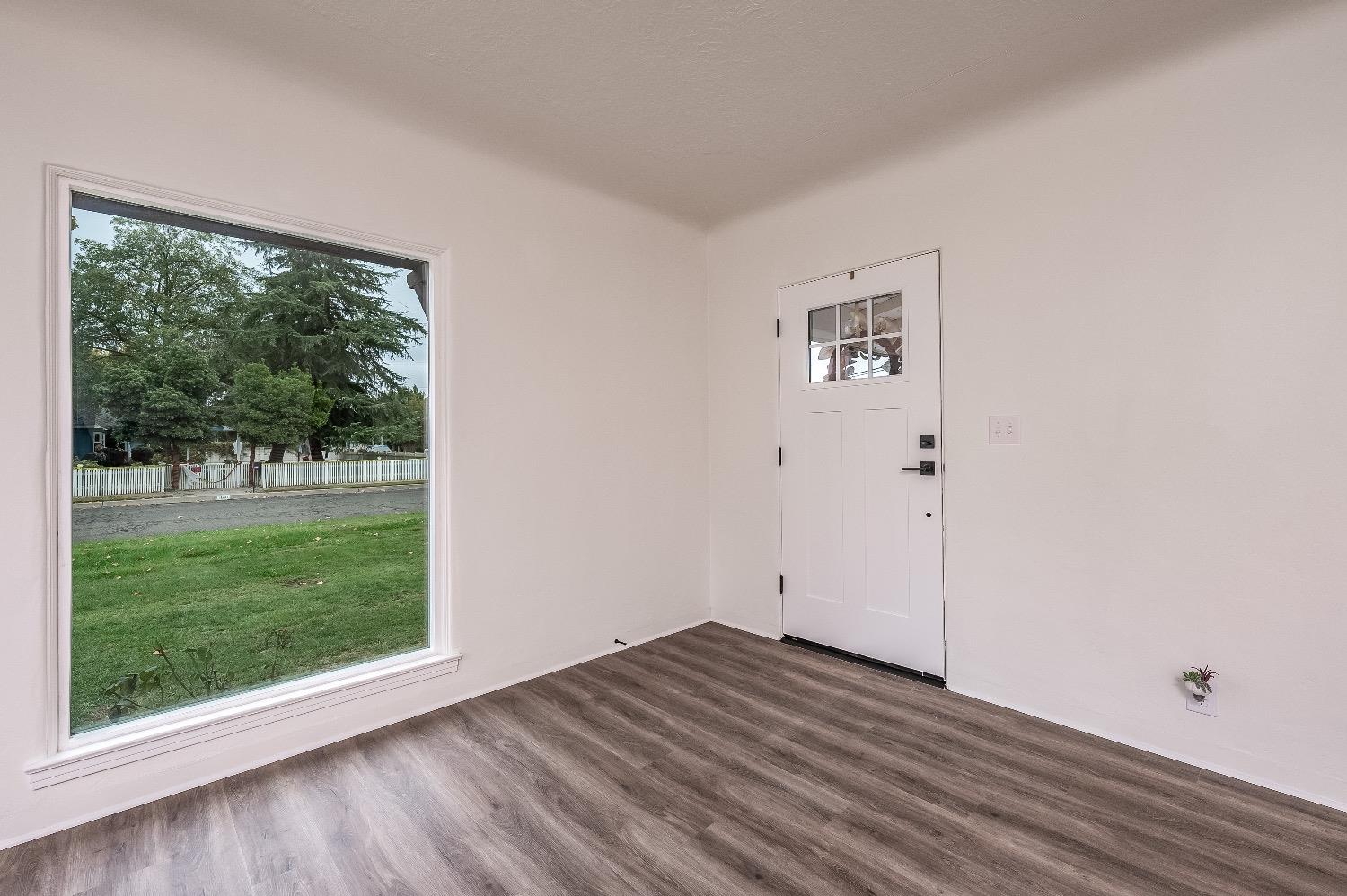 1600 West 5th Street Madera, CA 93637 - Photo 6 of 46 a view of a room with wooden floor and a window
