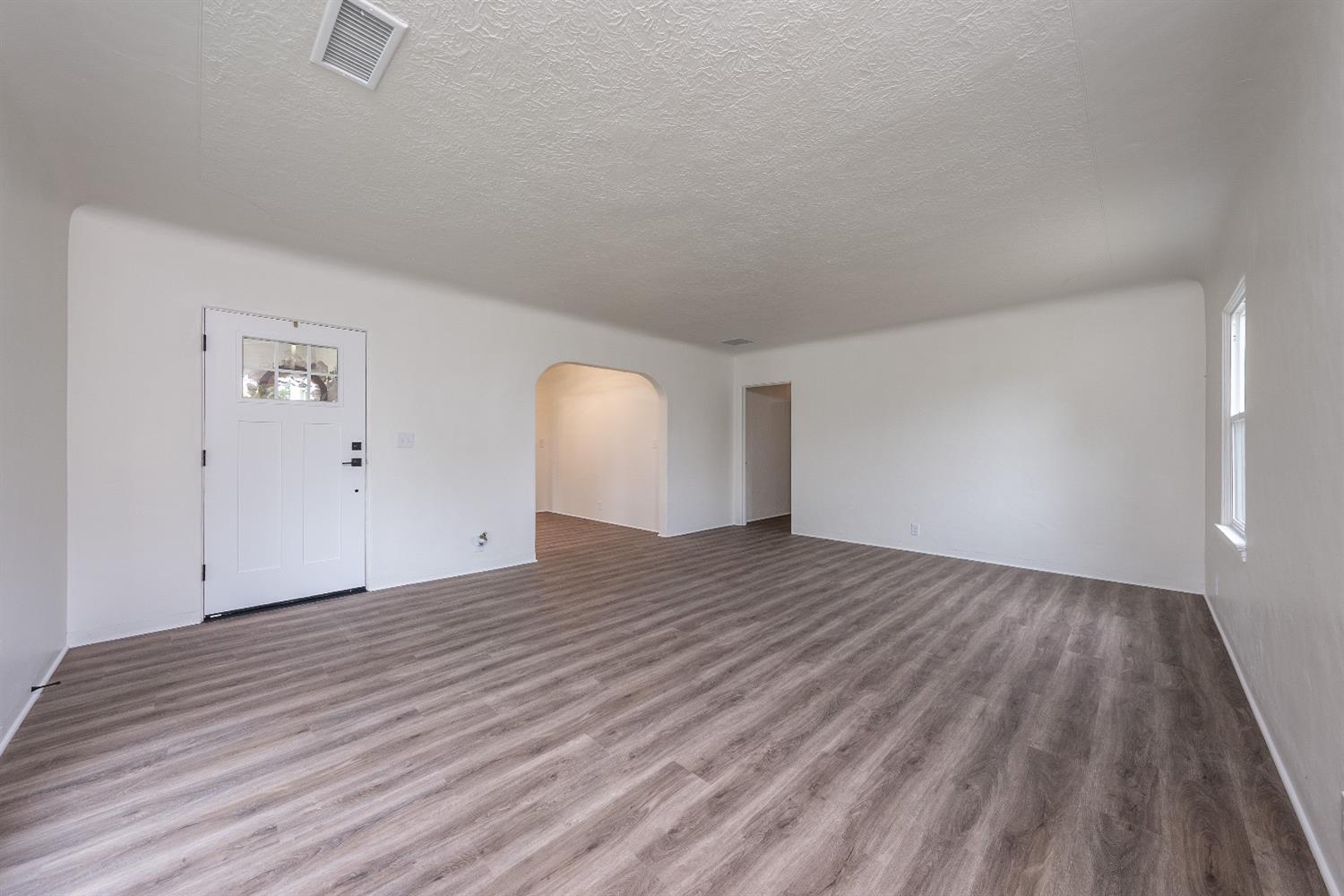 1600 West 5th Street Madera, CA 93637 - Photo 7 of 46 a view of an empty room and wooden floor