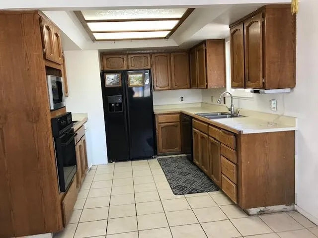 a kitchen with a sink stove and refrigerator