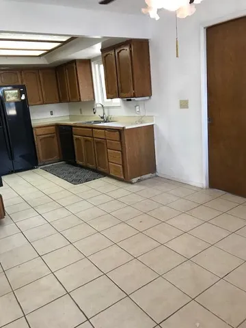 a kitchen with stainless steel appliances a sink and cabinets