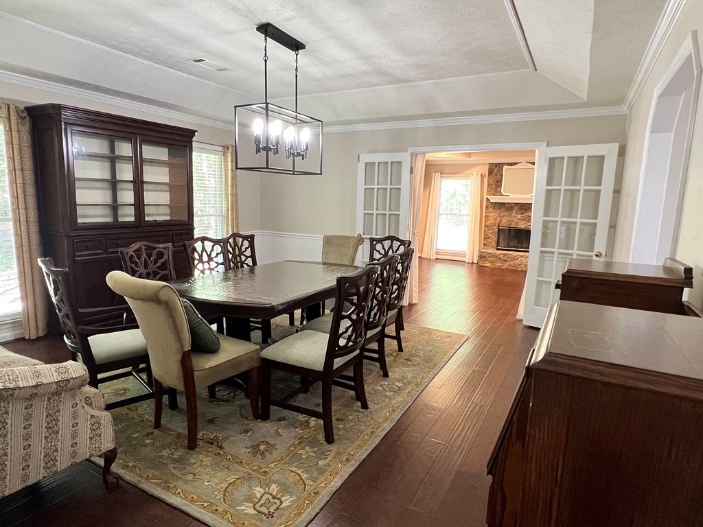 488 Blue Bird Trail Fortson, GA 31808 - Photo 12 of 45 a view of a dining room with furniture wooden floor and chandelier