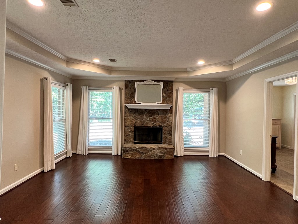 488 Blue Bird Trail Fortson, GA 31808 - Photo 14 of 45 an empty room with wooden floor fireplace and windows