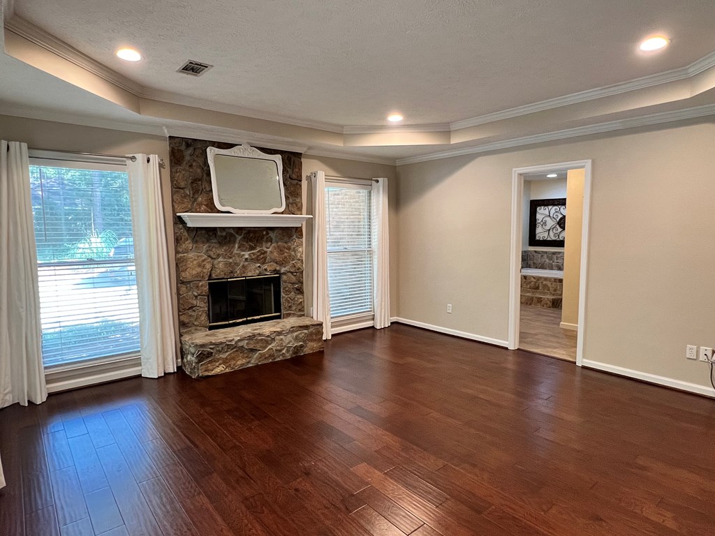 488 Blue Bird Trail Fortson, GA 31808 - Photo 15 of 45 an empty room with wooden floor fire place and windows