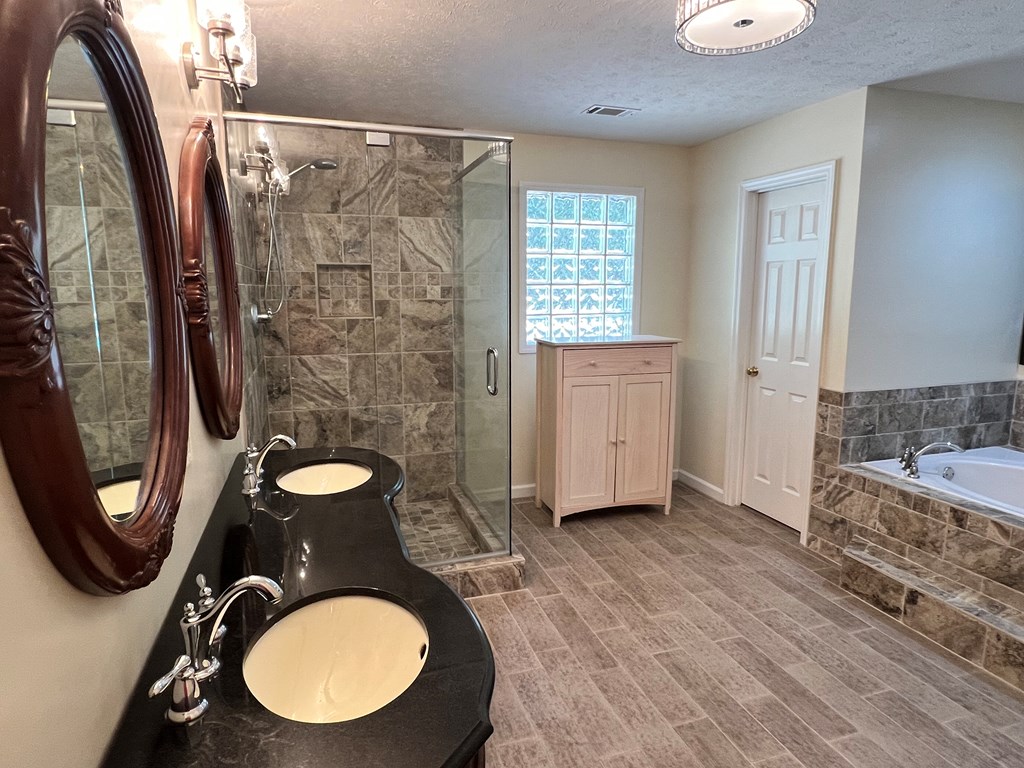 488 Blue Bird Trail Fortson, GA 31808 - Photo 16 of 45 a bathroom with a granite countertop double vanity sink mirror and painting on the wall