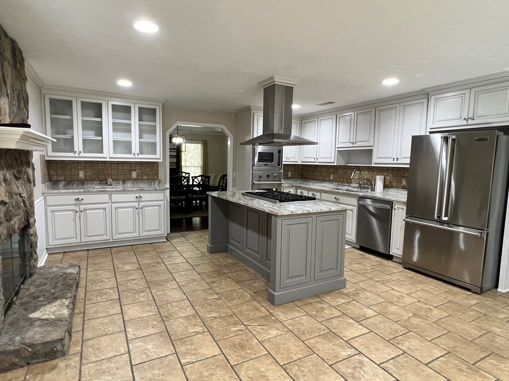 488 Blue Bird Trail Fortson, GA 31808 - Photo 28 of 45 a kitchen with stainless steel appliances granite countertop a refrigerator sink and cabinets