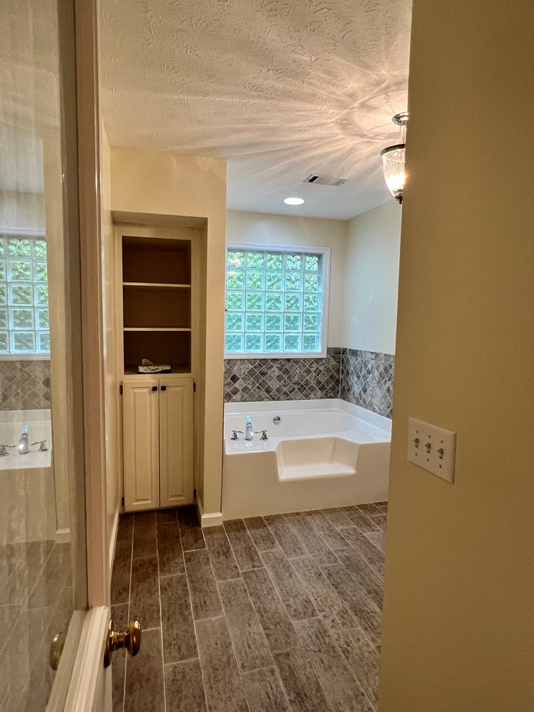 488 Blue Bird Trail Fortson, GA 31808 - Photo 33 of 45 a bathroom with a bathtub and a shower