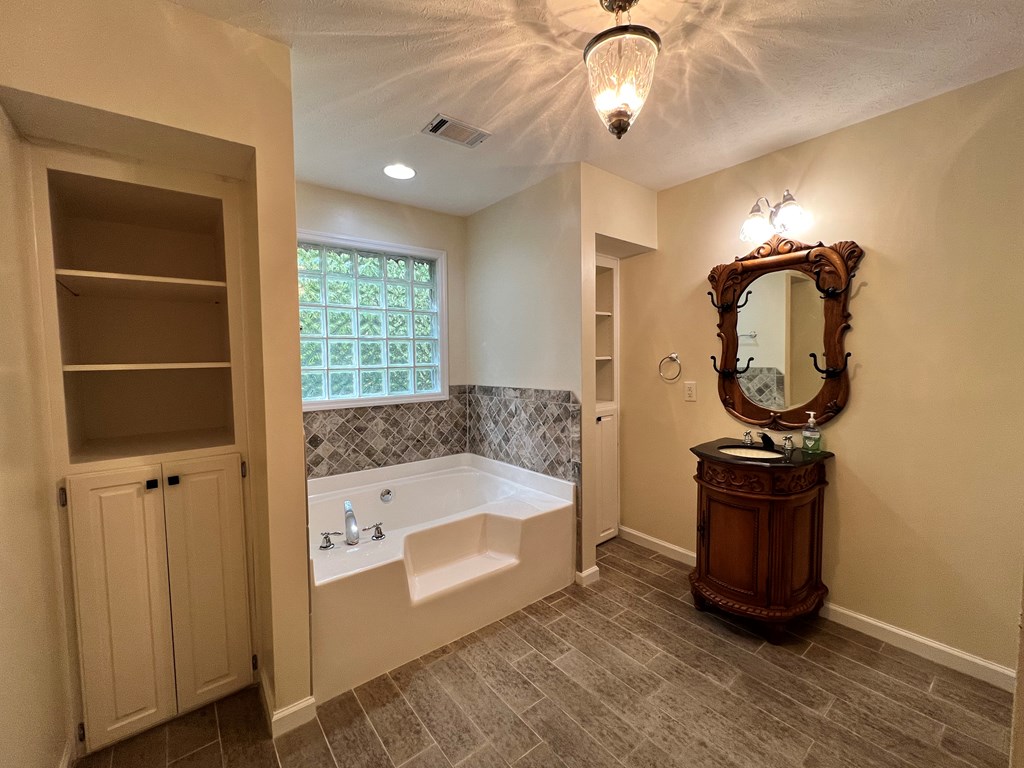 488 Blue Bird Trail Fortson, GA 31808 - Photo 35 of 45 a bathroom with a sink a bathtub and a window