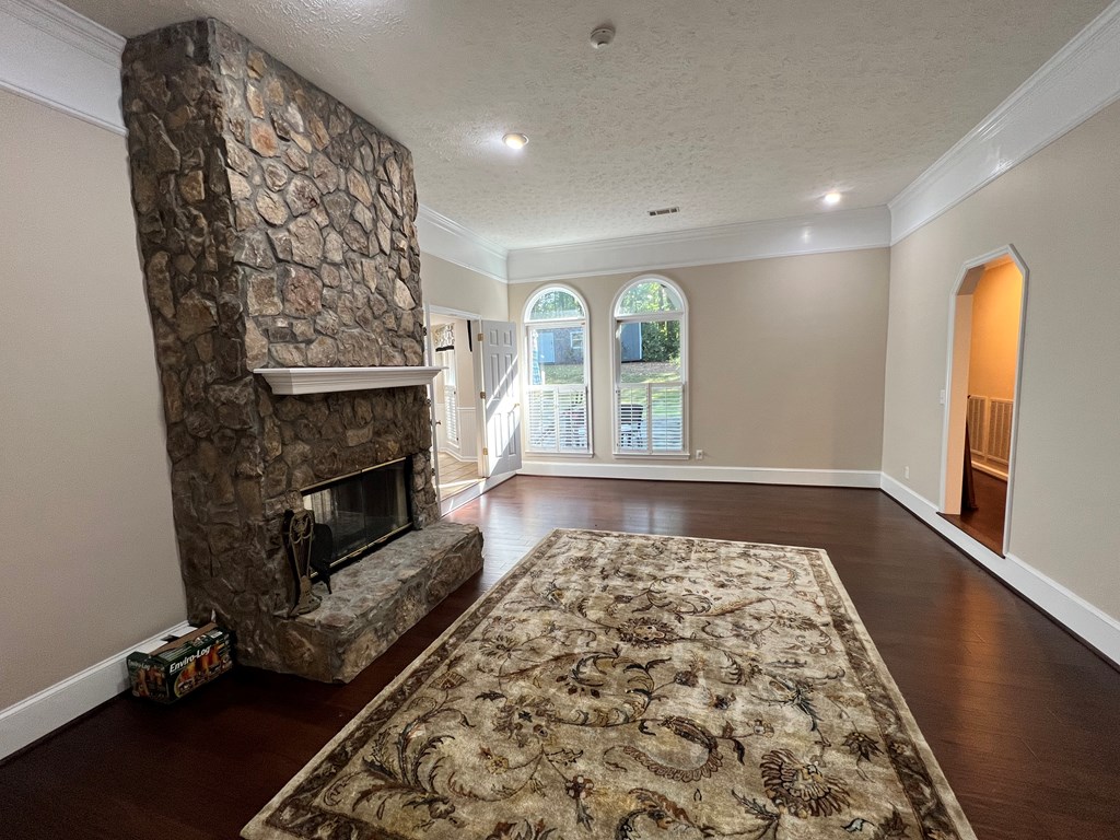 488 Blue Bird Trail Fortson, GA 31808 - Photo 8 of 45 a view of an empty room with a fireplace and wooden floor
