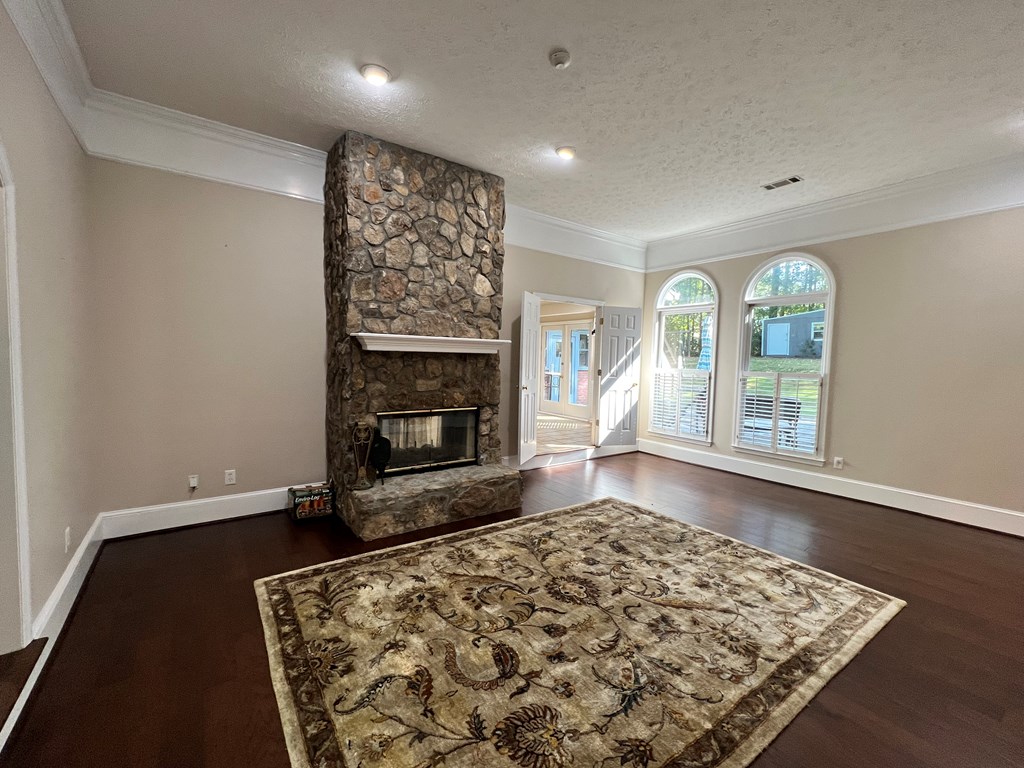 488 Blue Bird Trail Fortson, GA 31808 - Photo 9 of 45 an empty room with windows and fireplace