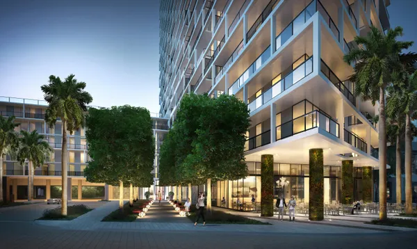 a view of a white house with a yard and potted plants