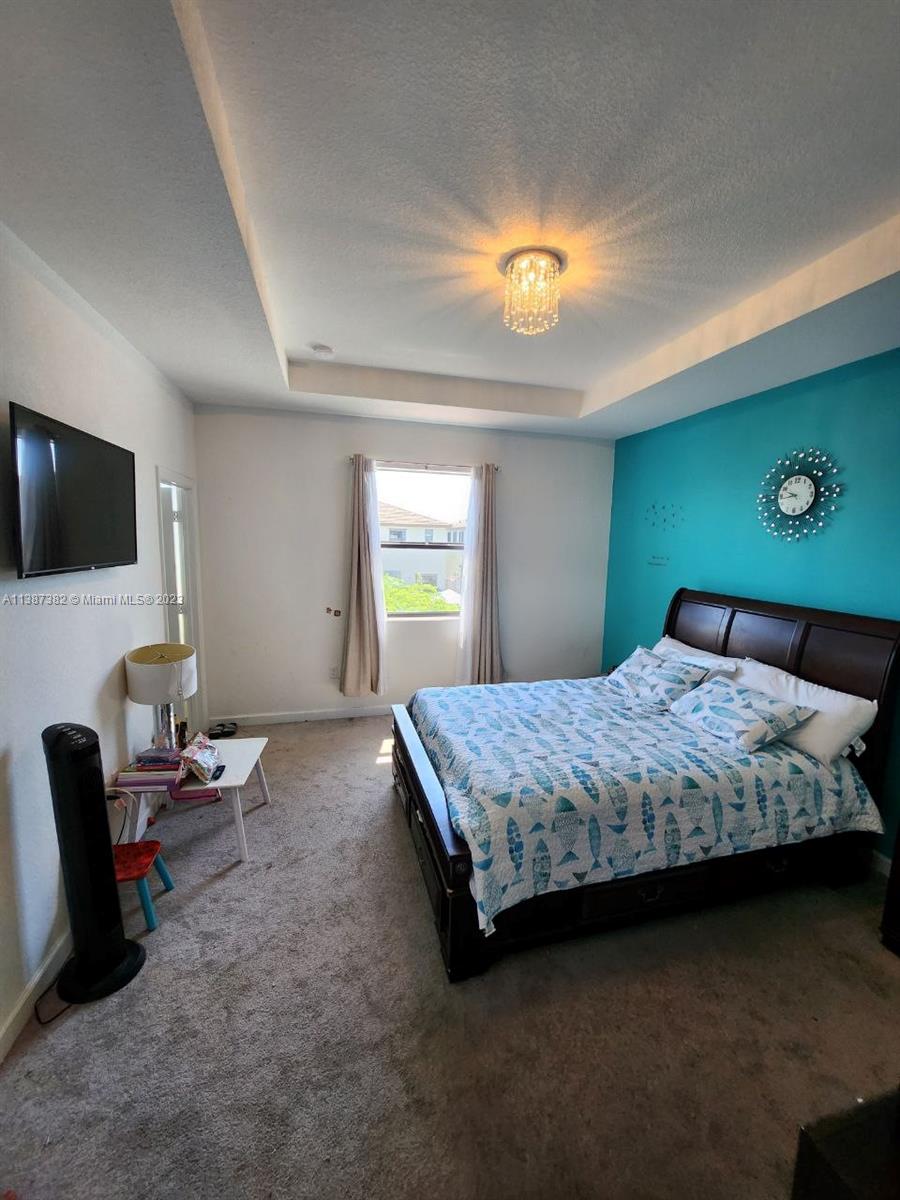 25151 Southwest 108th Court Homestead, FL 33032 - Photo 11 of 15 a bedroom with a bed and a flat screen tv