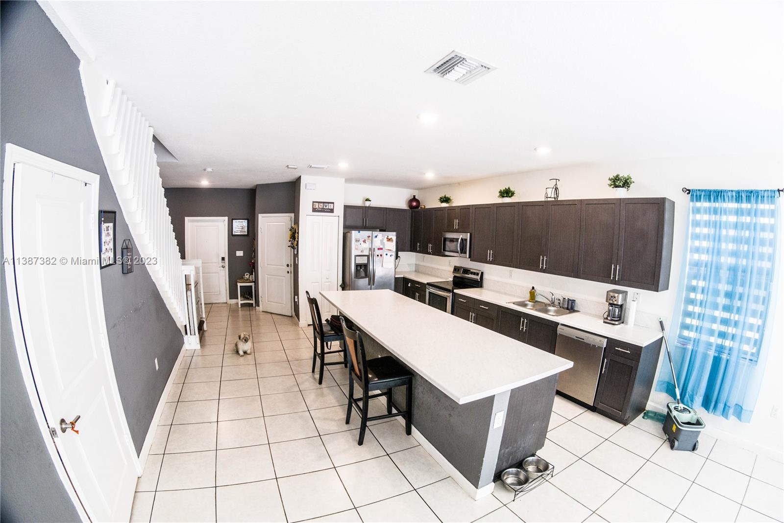 25151 Southwest 108th Court Homestead, FL 33032 - Photo 2 of 15 a room with furniture a rug and white walls