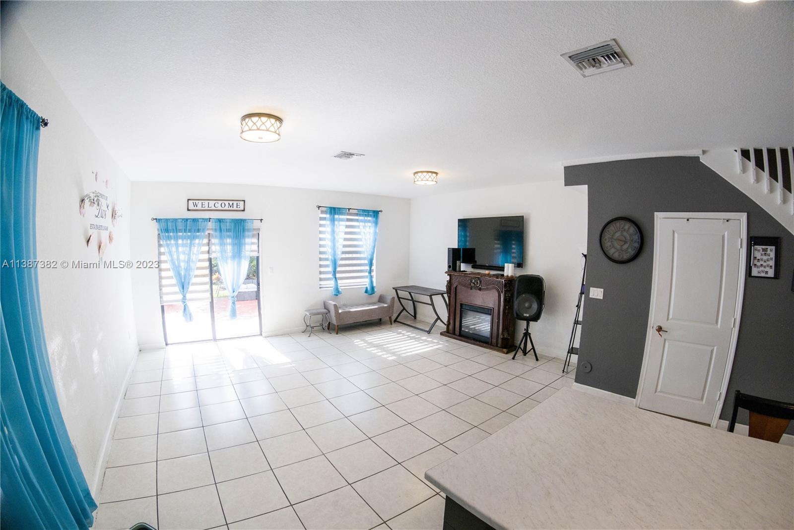 25151 Southwest 108th Court Homestead, FL 33032 - Photo 6 of 15 a living room with furniture and a flat screen tv