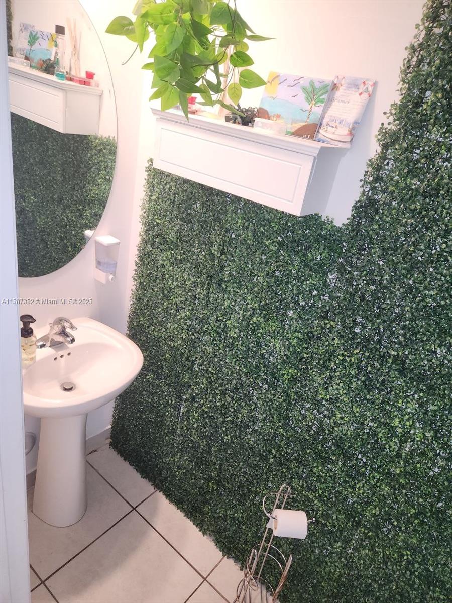 25151 Southwest 108th Court Homestead, FL 33032 - Photo 7 of 15 a bathroom with a sink and mirror