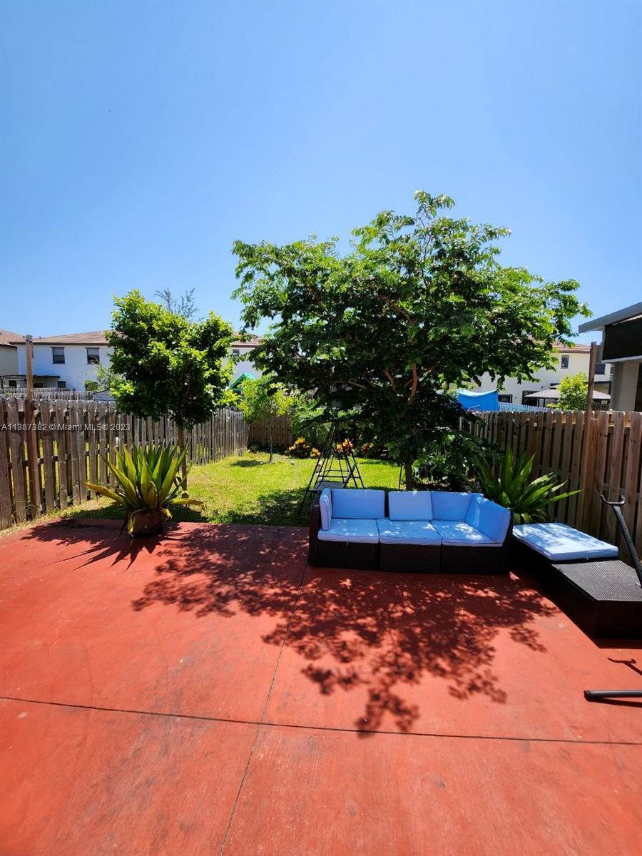 25151 Southwest 108th Court Homestead, FL 33032 - Photo 9 of 15 a view of a backyard with plants and large trees