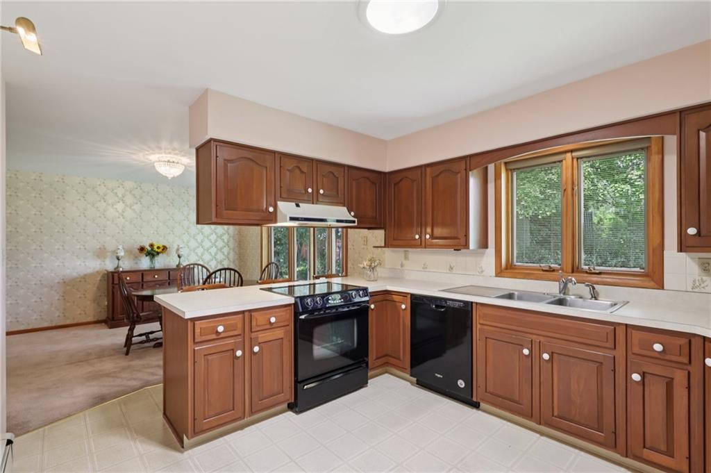 100 Joshua Drive Harmony, PA 16037 - Photo 15 of 39 a kitchen with a sink stove and cabinets