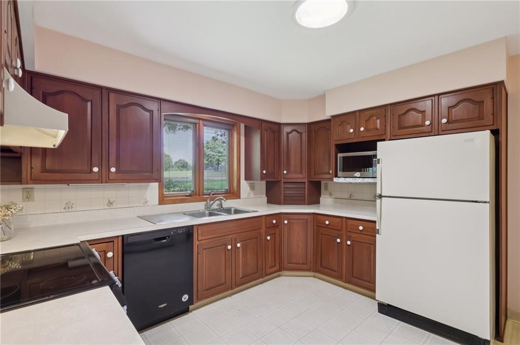100 Joshua Drive Harmony, PA 16037 - Photo 16 of 39 a kitchen with a sink a stove and refrigerator
