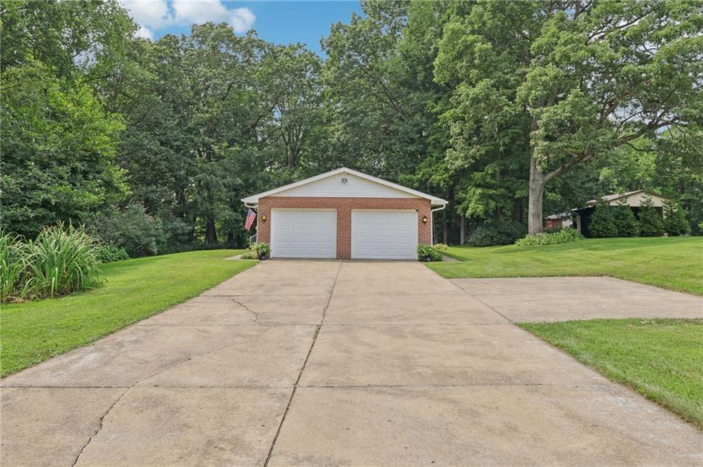100 Joshua Drive Harmony, PA 16037 - Photo 32 of 39 a front view of a house with yard garage and trees