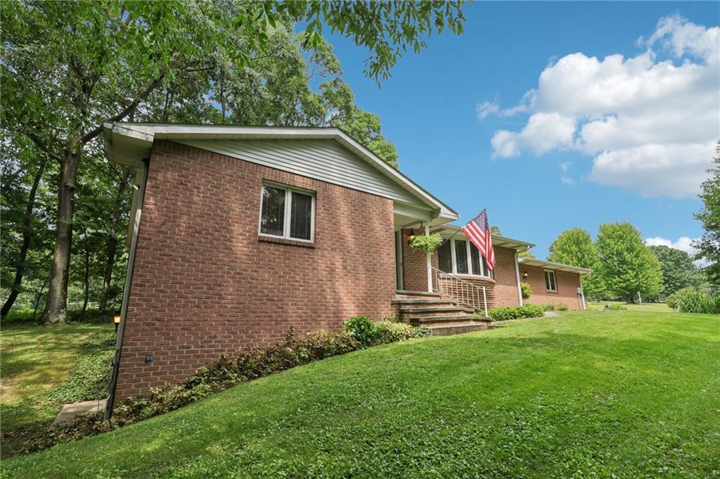 100 Joshua Drive Harmony, PA 16037 - Photo 33 of 39 a front view of a house with garden