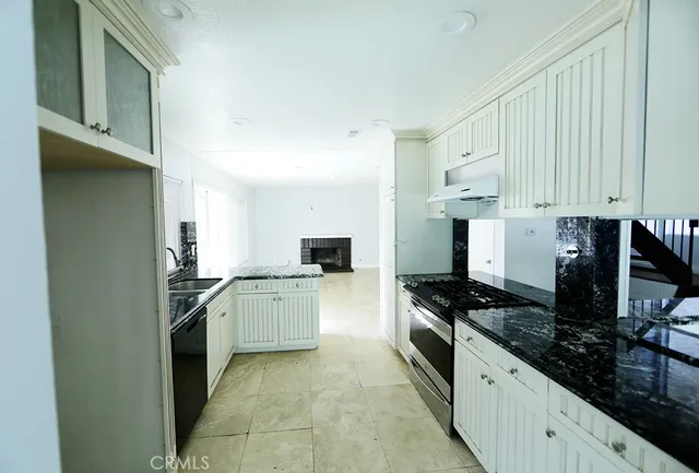 a kitchen with stainless steel appliances a stove a sink and a refrigerator