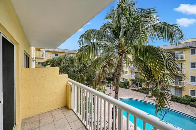 a view of a palm trees front of house