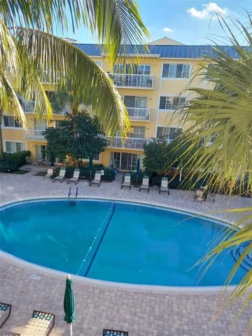 a view of swimming pool with outdoor seating and a patio