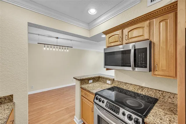 a stove top oven sitting inside of a kitchen