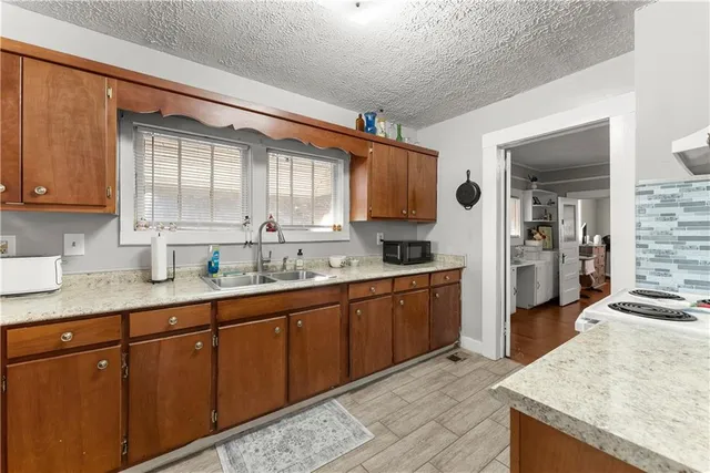 a kitchen with stainless steel appliances granite countertop a sink and cabinets