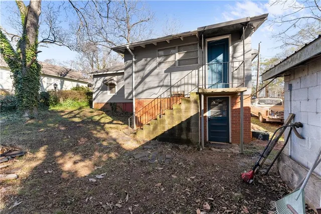a view of wooden house with a large tree