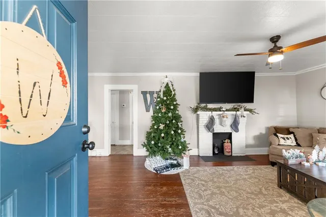 a living room with fireplace furniture and a flat screen tv